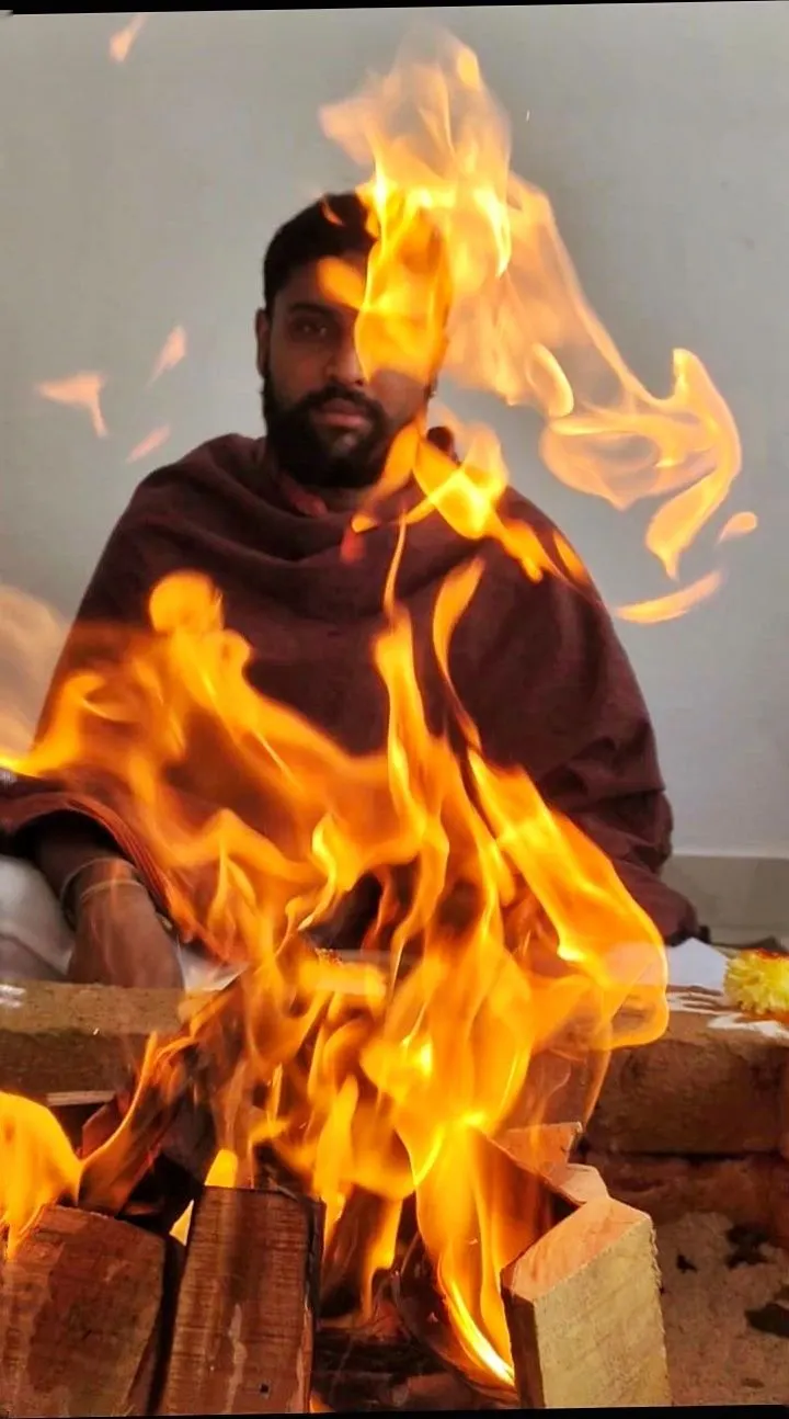 Dr. Rohit S. Patil seated behind the sacred Homa fire